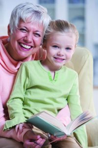 Grandmother Reading with Granddaughter --- Image by © Royalty-Free/Corbis
